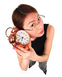 a woman listening to a clock tick